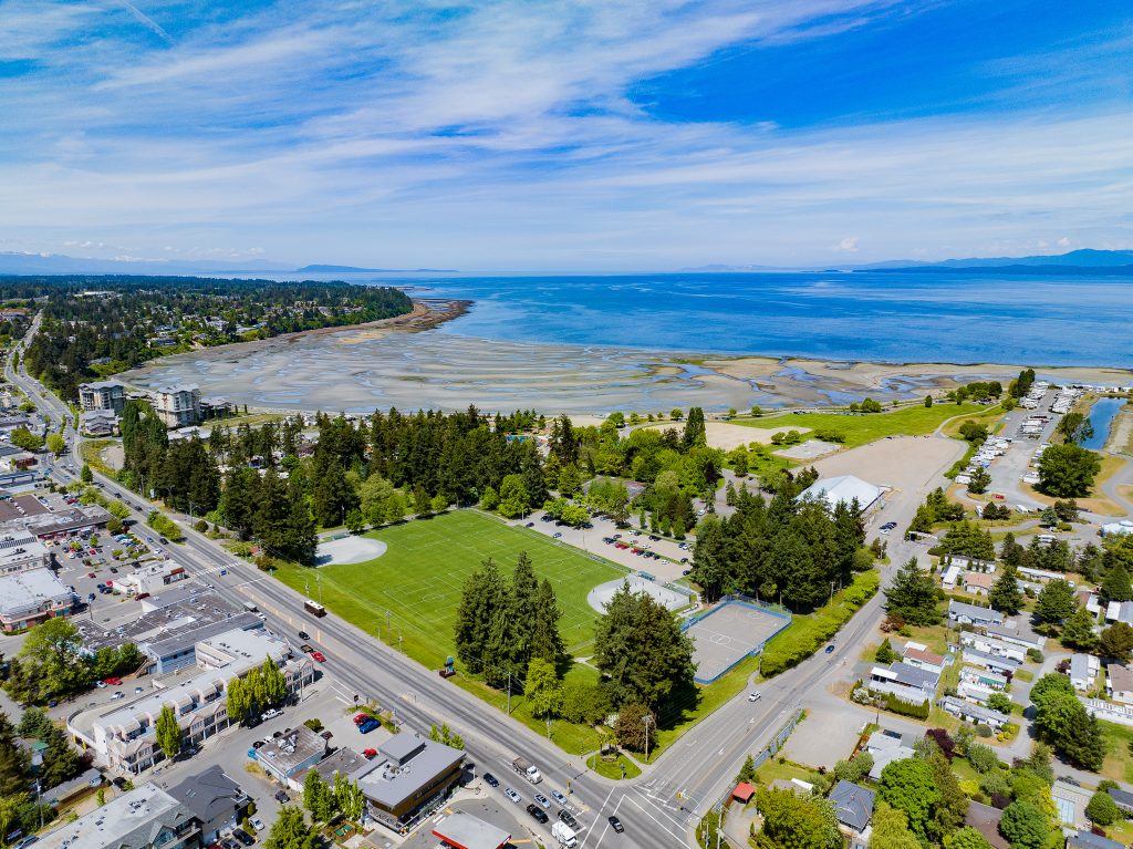 panoramic photo of a beachside surrounded by houses